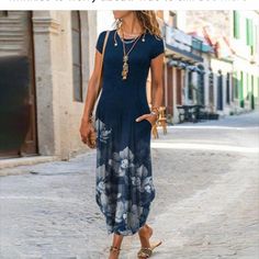 a woman in a blue dress is walking down the street with her hand on her hip