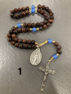 Quality stone bead Rosaries with metal Crucifix and Miraculous medal. My supplies vary so no two look exactly alike- they may vary in string and bead color/ type. Here are pictures of the small stone bead Rosaries I have currently made. These look nicer than knot Rosaries and are very durable. These ones are made with leather cord, 6mm beads, and measure just under 12 inches in length. I've always loved making Rosaries and in the past I've just given them away. I'm not really selling these for t Adjustable Rosary With Oval Beads As Gift, Round Beads Rosary With Natural Stones For Gift, Gift Rosary With Round Natural Stones, Beaded Brown Rosary Gift, Brown Beaded Rosary As Gift, Brown Beaded Rosary Gift, Brown Healing Rosary With Round Beads, Brown Hand-strung Rosary As Gift, Healing Brown Rosary With Round Beads