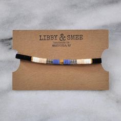 Like little works of art you can wear, these stretch tila bead tile bracelets — all in exclusive Libby & Smee patterns — are perfect on their own or worn in sets. Stacking is strongly encouraged.Style: MIDNIGHT COLORBLOCK - Black, navy, ivory, beige, gold, and transparent grey+ glass and gold-plated tile beads on two stretch cords+ closures are finished with gold-plated crimp covers (lead-free and nickel-free)+ comes in one 7" size to fit most wrists+ all Libby & Smee beaded bracelets co Tila Bracelets, Beige Bracelet, Tile Bracelet, Grey Glass, Layered Bracelets, Beaded Hoops, Big Earrings, Beaded Dangle Earrings, Beaded Dangles