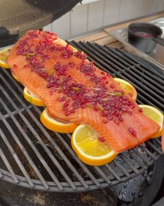 salmon and lemons are being grilled on the grill