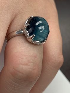 7.76 Carat Oval Shaped Cats's Eye Blue Tourmaline set in 18 karat white gold with 6 prongs and 0.28 carats of micro pave set diamonds graded G in color and SI1 in clarity. This ring is custom designed for this very special gemstone. Dare to be Di... White Gold Tourmaline Ring With Prong Setting, White Gold Tourmaline Jewelry With Prong Setting, Tourmaline White Gold Jewelry With Prong Setting, Elegant Polished Diamond Gemstones, Polished Round Diamond Gemstones, Round Diamond Gemstones With Polished Finish, Luxury White Gold Polished Gemstones, Silver Platinum Gemstones With Vvs Clarity, Exquisite Platinum Gemstones With Prong Setting