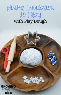 a wooden plate with play dough on it and scissors, sprinkles, and other items