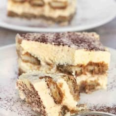 two pieces of cake sitting on top of a white plate with a fork in it