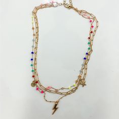 This multi chain necklace is everyones favorite. With the neon multicolor beads, the lightning bolt and stars are perfect for every outfit. Lightning Necklace, Multi Chain Necklace, The Lightning, Lightning Bolt, Chain Necklace, Neon, Necklaces, Rainbow, Beads