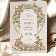 an ornate wedding card with flowers on it