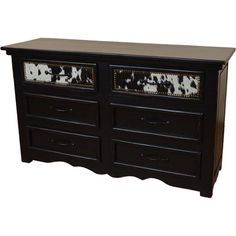 a black and white cow print dresser with drawers