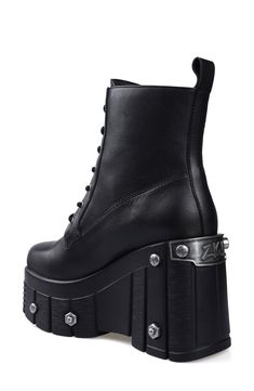 Bring bold biker edginess to your footwear collection with this heavy-duty combat boot set upon a lugged platform wedge studded with rivet-style screws and bolts. 4" heel; 3" platform 6" shaft Lace-up style Water resistant Leather upper and lining/rubber sole Imported Alternative Style Platform Boots With Studded Outsoles, Gothic Leather Combat Boots With Platform, Edgy Leather Wedge Boots For Alternative Fashion, Alternative Leather Platform Wedge Boots, Edgy Leather Wedge Boots For Streetwear, Edgy Leather Wedge Boots With Chunky Platform, Leather Platform Combat Boots For Alternative Fashion, Leather Wedge Boots With Chunky Platform In Alternative Style, Leather Wedge Boots With Chunky Platform