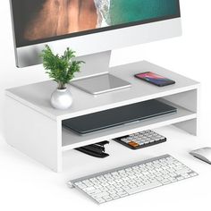 a computer monitor sitting on top of a white desk next to a keyboard and mouse