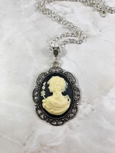 This beautiful goddess cameo necklace is the perfect way to show your love for mythology in an elegant way.This necklace features Greek goddess Persephone. Persephone is the goddess of spring and queen of the underworld. This artwork presents her in her spring maiden aspect.Available in a variety of lengths. Secured with a lobster clasp that can fit in any of the links on the chain, making it easily adjustable.All materials are lead and nickel free. Frame and chain are made out of zinc alloy. Ca Gothic Cameo Necklace As Gift, Gothic Cameo Necklace For Gift, Gothic Cameo Necklaces As Gift, Gothic Cameo Necklaces For Gifts, Antique Silver Victorian Necklace, Greek Goddess Persephone, The Goddess Of Spring, Goddess Persephone, Goddess Of Spring