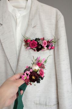 a person in a white suit with flowers on his lapel