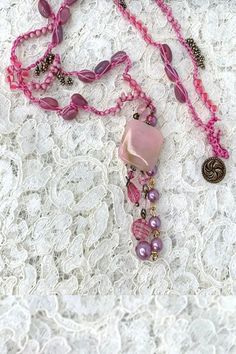 This Dusty Rose beaded jewelry necklace is hand crocheted with seed beads and measures about 32 inches long. This tantalizing accessory may be worn as a full-length necklace or bracelet. An intriguing dusty rose necklace is made up of vintage pink seed beads. #jewelry #earrings #handmade #designer #vintagebeads #dropearrings #shrinkydink #handpainted #Necklace Pink Bohemian Lariat Jewelry, Bohemian Pink Lariat Jewelry, Pink Crochet Bohemian Necklace, Pink Crochet Necklace, Handmade Pink Lariat Jewelry, Handmade Bohemian Pink Beads, Handmade Pink Bohemian Beads, Bohemian Pink Crochet Jewelry, Adjustable Pink Bohemian Lariat Necklace