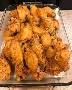 fried chicken in a glass dish on a counter