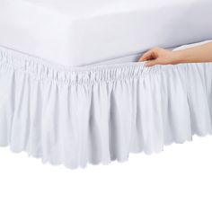 the bed skirt is white with ruffles on it