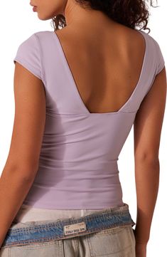 A dipped corset-like neckline begins this shapely top styled with cap sleeves. 19 1/2" length (size Medium) V-neck Cap sleeves 88% nylon, 12% spandex Hand wash, line dry Imported Fitted Lavender Short Sleeve Top, Lavender Fitted V-neck Tops, Purple V-neck Top With Built-in Bra, Free People Duo Corset, Corset Top, Cap Sleeves, Top Styles, Lavender, Free People