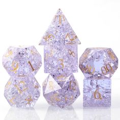 three purple and gold dice with numbers on them