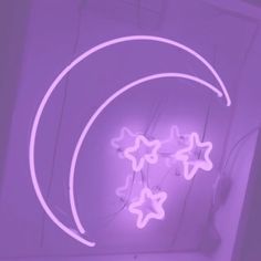 a purple neon sign with stars hanging from it