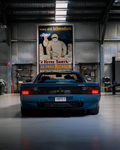 a blue sports car parked in a garage