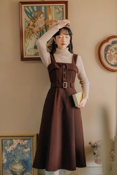 Midi pinafore dress with thick shoulder straps, button front, belted waist, side pockets and pleated skirt. Concealed back zipper. S: 33" chest, 27" waist, 42" lengthM: 34.5" chest, 28.5" waist, 42" lengthL: 36" chest, 30" waist, 42.5" lengthXL: 37.5" chest, 31.5" waist, 42.5" length Sleeveless Dress With Adjustable Straps For Fall, Sleeveless Dresses With Adjustable Straps For Fall, Workwear Midi Dresses With Adjustable Straps, Midi Length Dresses With Adjustable Straps For Work, Winter Workwear Dress With Belt, Vintage Sleeveless Pinafore Dress For Fall, Pinafore Dress With Buttons For Workwear, Fall Sleeveless Pinafore Dress For Workwear, Square Neck Winter Workwear Dress