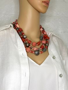 One-of-a-kind handcrafted statement necklace. Beads: 3 strands of Tibetan faux coral (glass), carved coral and glass, antique and sterling silver Dimensions: approximately 24" + 2.5" extender Make a statement with this delightful necklace! Free Shipping Refund Policy Multi-strand Red Coral Beaded Necklaces, Coral Multi-strand Beaded Necklaces, Coral Multi-strand Beaded Necklace, Coral Red Multi-strand Beaded Necklaces, Coral Beaded Multi-strand Necklace, Coral Multi-strand Beads For Jewelry Making, Multi-strand Coral Beaded Necklace As Gift, Multi-strand Coral Beaded Necklace For Gift, Coral Multi-strand Beaded Necklace For Gift