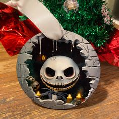 a christmas ornament with a jack skellingy face on it