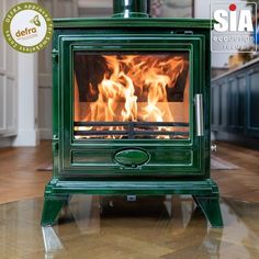 a green stove sitting on top of a hard wood floor