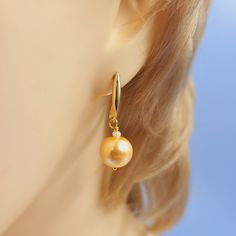 Two incredibly crafted 10mm x 10mm sphere-shaped Golden Pearls, complimented by two wonderful 3mm x 2mm sphere-shaped Fresh Water Pearls, handset in gold-plated sterling silver. Pearl is the birthstone for June and means nobility, beauty & peace! These handmade gemstone earrings are 30mm long (~1 Inch) and come boxed and in an organza bag, which is beautifully presented, making it an ideal gift. Thanks for looking. Commissions welcome. PJ4890 Your jewellery is sent safely tracked worldwide, now Elegant Hypoallergenic Jewelry With Round Beads, Elegant Nickel-free Jewelry With Round Beads, Elegant Hypoallergenic Round Bead Earrings, Handmade Elegant Spherical Jewelry, Formal Hypoallergenic Jewelry With Round Beads, Hypoallergenic Formal Jewelry With Round Beads, Hypoallergenic Round Bead Jewelry For Formal Occasions, Elegant Round Pendant Earrings With Ear Wire, Nickel-free Yellow Gold Pearl Earrings