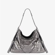 Medium Shoulder Bag In Laminated Leather. Voyou Line. V-Shaped Slouchy Silhouette. Adjustable Shoulder Strap Offering Hand, Shoulder Or Crossbody Carrying. Givenchy Engraved Metal Buckles. Silvery-Finish Metal Details. Givenchy Signature Embossed On The Front Of The Bag And On The Top Of The Shoulder Strap. One Main Compartment And One Inside Zipped Pocket. Adjustable Shoulder Strap Length From 11.4 To 39.8 In. Minimal Drop : 6.3 In And Maximal Drop : 21.2 In. Color Silvery Grey Composition 100% Givenchy Crossbody Bag, Givenchy Bag, Womens Designer Handbags, Medium Bags, Chain Bags, Metallic Leather, Metal Buckles, Leather Satchel, Hobo Bag