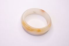 "White and Brown Jade Bangle | Marble Style Bangle | Stunning Exterior measurement: 3.104\" Interior measurement: 2.379\" Bangle Width: 18.55mm Bangle Length: 10" Vintage White Bangle For Wedding, Vintage White Wedding Bangle, Adjustable White Round Cuff Bracelet, Adjustable White Bangle For Formal Occasions, Modern Adjustable White Bangle, Adjustable Round Bangle For Formal Occasions, Formal Adjustable Round Bangle, Adjustable Formal Bangle, White Adjustable Cuff Bracelet For Formal Occasions