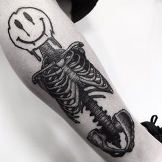 a black and white photo of a skeleton tattoo