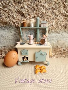 an old fashioned toy stove with eggs on the floor