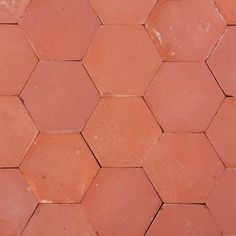 a close up view of a red hexagonal tile