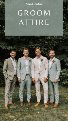 a group of men standing next to each other in front of some trees and grass