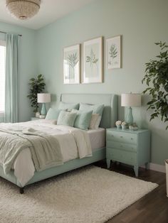 a bedroom with mint green walls and white rugs on the floor, along with a large bed