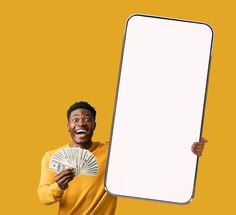 a man holding a blank board and money in one hand while standing against a yellow background