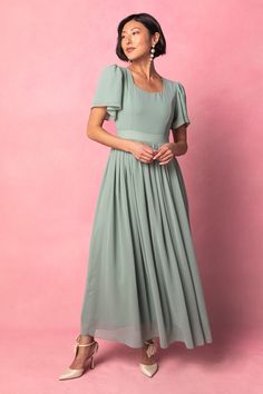 Say hello to the Abbie Dress in Sage. With princess seams and a subtle sweetheart neckline, this gown is the perfect modest bridesmaid dress. The soft green base color is complemented by a maxi length skirt with functional pockets, while the short flutter sleeve adds a touch of femininity. With a hidden back zipper and lining throughout, this dress provides both style and comfort. Fabric with some stretch ensures a perfect fit every time. Bridesmaid Dress Short Sleeve, Grad Dresses Modest, Green Tea Dress, Mission Outfits, Modest Bridesmaid Dress, Ivy City Co, Sage Green Bridesmaid Dress, Lover Dress, Sage Green Dress