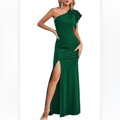 a woman in a green dress with one leg slited and the other side split open