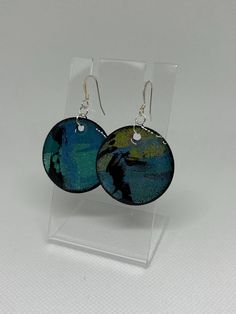 Hand-painted and created paper earrings with resin coating. Original and one-of-a-kind. Circular, flat drop/dangle earrings. Hand painted. Pearlized blue with light green, turquoise and black accents. Resin coating on both to add shine and durability. Add some artwork to your ears and make your outfit "pop"! Turquoise And Black, Paper Earrings, Resin Coating, Black Accents, Etsy Earrings Dangle, Jewelry Earrings Dangle, Dangle Drop Earrings, Hand Made, Dangle Earrings