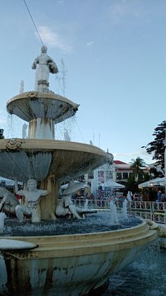 a water fountain with statues on top