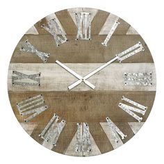 a wooden clock with metal roman numerals on the face and numbers in different colors