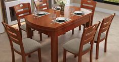 a dining room table with chairs and plates on it in front of an open window