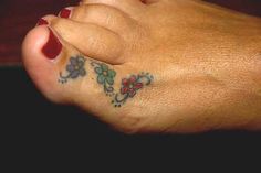 a woman's foot with tattoos on it