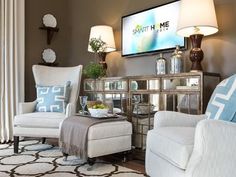 a living room filled with furniture and a flat screen tv mounted to the side of a wall