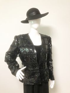 This is a fully beaded jacket from Nolan Miller. The entire jacket is covered in black sequins. The addition of fringed bugle beads gives this piece movement and extra sparkle. The jacket if fully lined and closes in front with a hook covered with a beaded button. Shoulder pads. Size tag is 12, but it fits more like an 8. Check measurements carefully, as there is no stretch. Measurements taken with jacket laying flat and doubled where appropriate. In order to determine fit we recommend comparing Embellished Black Blazer For Fall, Black Embellished Fall Blazer, Winter Embellished Black Blazer, Winter Black Embellished Blazer, Sequined Outerwear For Holiday Evenings, Black Embellished Evening Blazer, Fitted Sequin Blazer For Fall, Winter Evening Outerwear With Sequins, Black Holiday Evening Blazer