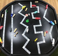 a black tray with toy cars on it