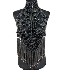 Introducing the Luxury Rhinestone Chain Shirt from Primadons and Donnas. This stylish and innovative shirt is sure to turn heads. It features a full rhinestone chain front and a halter style in the back. It's the perfect way to make a statement and stand out from the crowd. This shirt is made from high-quality materials and is designed to last. Plus, it ships in just 1 business day, so you can get it fast. So don't wait, get your Luxury Rhinestone Chain Shirt today and show off your unique style Glamorous Fitted Body Chain For Evening Events, Glamorous Fitted Body Chain For Evening, Festival Crystal Body Chain With Rhinestones, Elegant Crystal Body Chain For Festivals, Glamorous Rhinestone Body Jewelry For Festivals, Elegant Embellished Body Jewelry For Parties, Glamorous Bling Body Jewelry For Evening, Glamorous Evening Body Jewelry With Bling, Glamorous Evening Crystal Body Jewelry