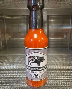 a bottle of hot sauce sitting on top of a counter