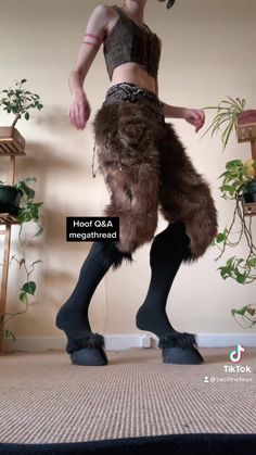 a woman in furry boots is standing on the floor with her legs spread wide open