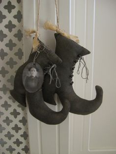 an elephant head hanging from the side of a door with two shoes attached to it