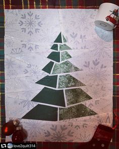 a christmas tree made out of scraps on a piece of paper and some scissors