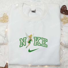 Introducing the Tinkerbell x Nike Cartoon Embroidered Sweatshirt, a must-have for all Disney lovers! This unique sweatshirt features an adorable Tinkerbell and Nike collaboration design, beautifully embroidered on soft, premium fabric. With its cozy fit and stylish appeal, it’s perfect for everyday wear or lounging around. Surprise your family with this Disney Characters Embroidered Shirt, an ideal gift for any occasion. Its intricate embroidery showcases beloved Disney characters, adding Disney Tinkerbell Shirt, Starbucks Christmas Cups, Nike Cartoon, Disney Character Shirts, Embroidered Apparel, Mike Wazowski, Frankenstein Halloween, Starbucks Christmas, St Patrick's Day Gifts